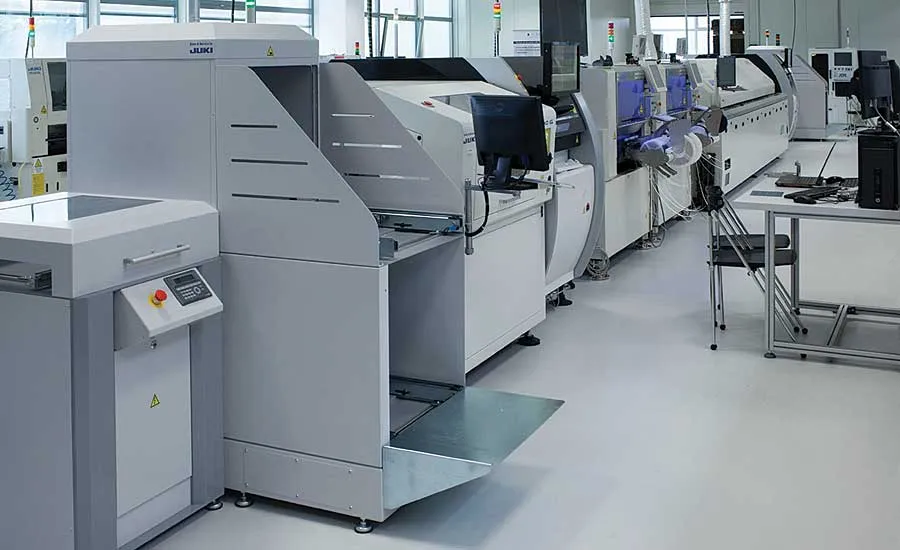 A PCB assembly line with various machines and workers.