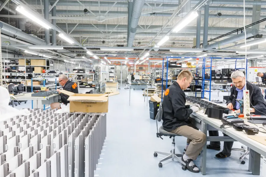 A factory floor with equipment used in PCB fabrication.