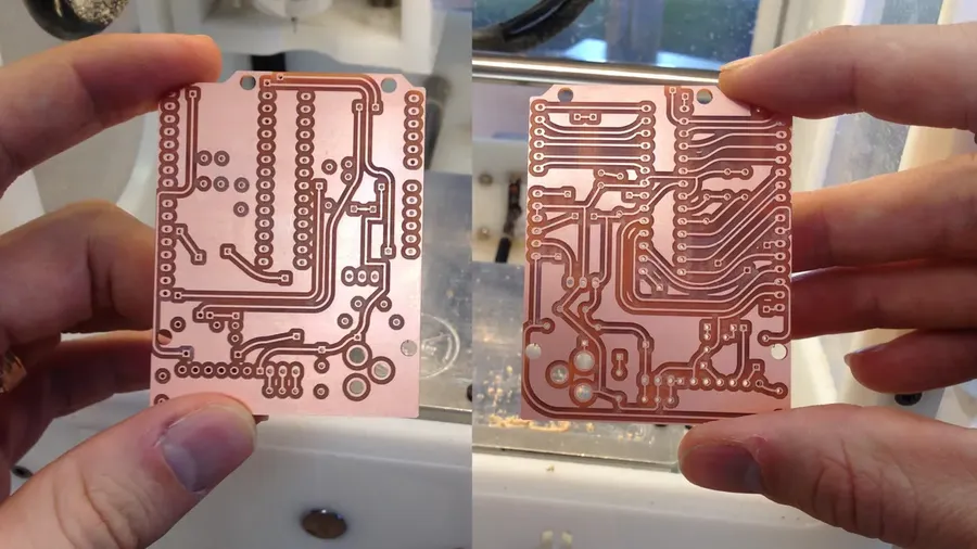 A double-sided printed circuit board showing both sides.