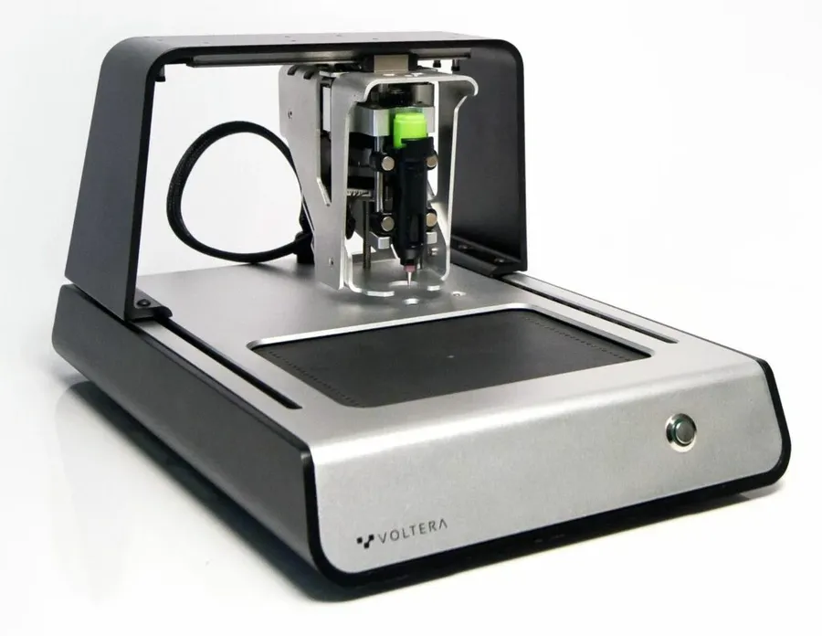 A low-cost PCB printer printing a circuit board.