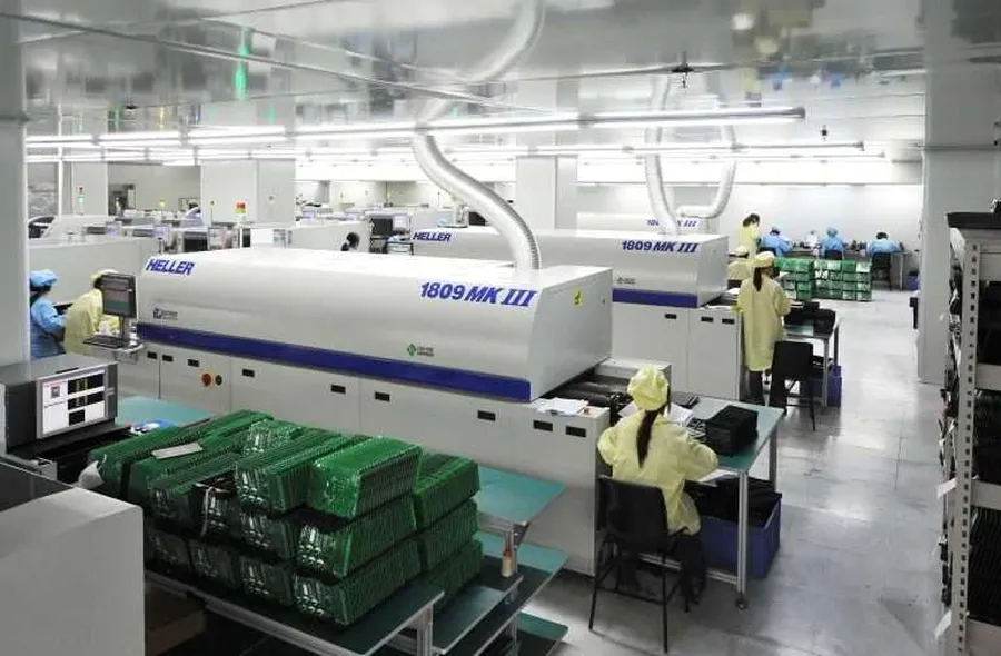 An image of a PCB manufacturing workshop with machines and workers.