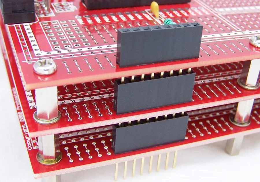 A stack of PCB boards ready for assembly.