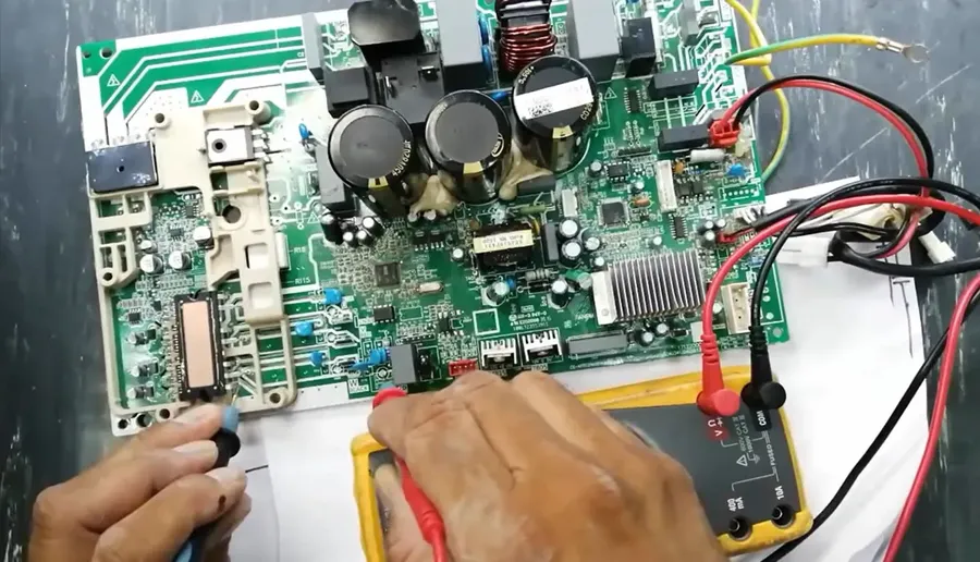 Close-up on a technician repairing an air conditioner PCB