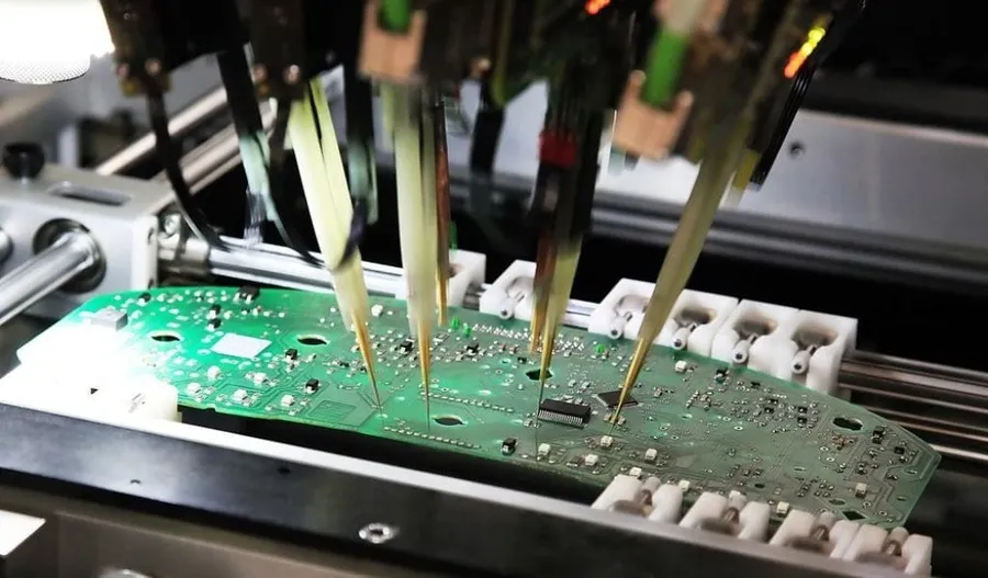 A PCB being tested with specialized testing equipment.