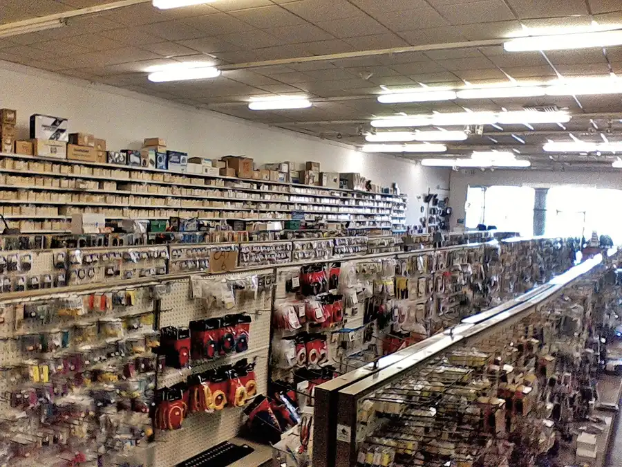 A shelf in an electronics store filled with various components.