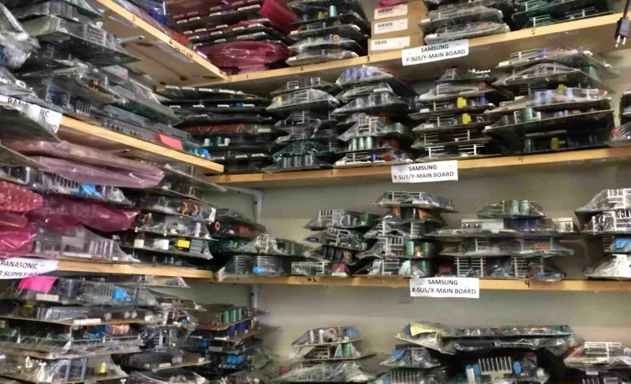A well-stocked shelf at an electronics store.