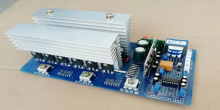 A variety of components like capacitors, transistors, and ICs on an inverter board.