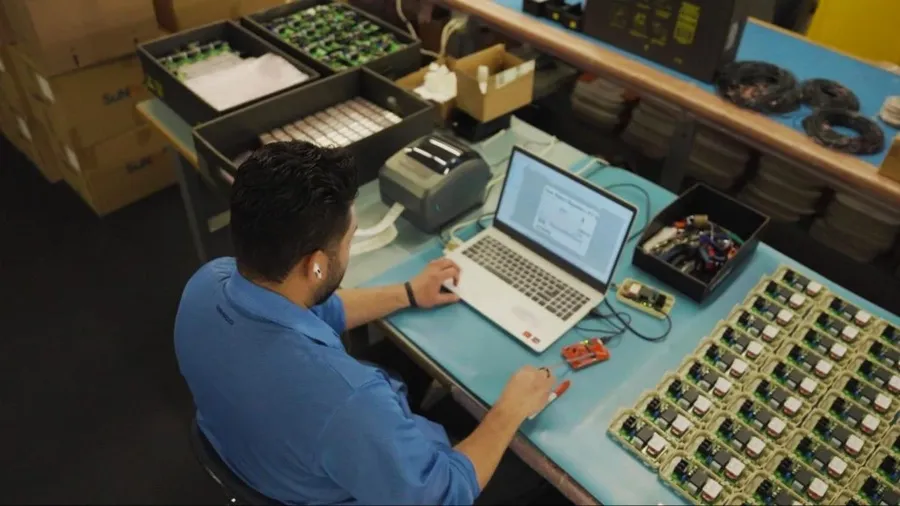 A PCB engineer working on a design at a computer workstation.