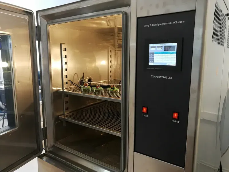 A PCB undergoing environmental stress screening (ESS) test in a chamber