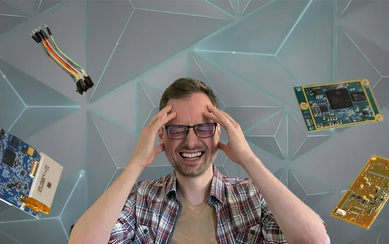 An engineer holding a PCB prototype board in a lab setting