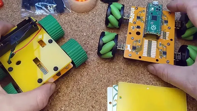 Engineers working on a complex robot PCB design, showing detailed traces and component layouts